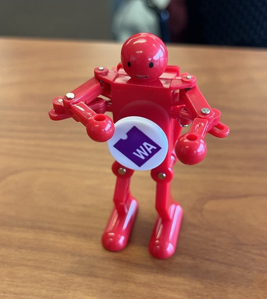 WasMan, a small red robot toy with a WebAssembly logo on its chest